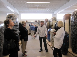 Jun's assistant showing the board members of ATA around the studio